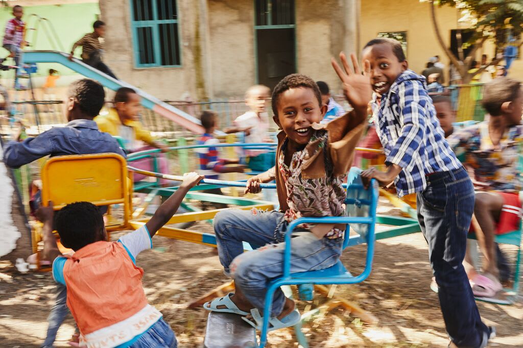 Boys on a playground laughing